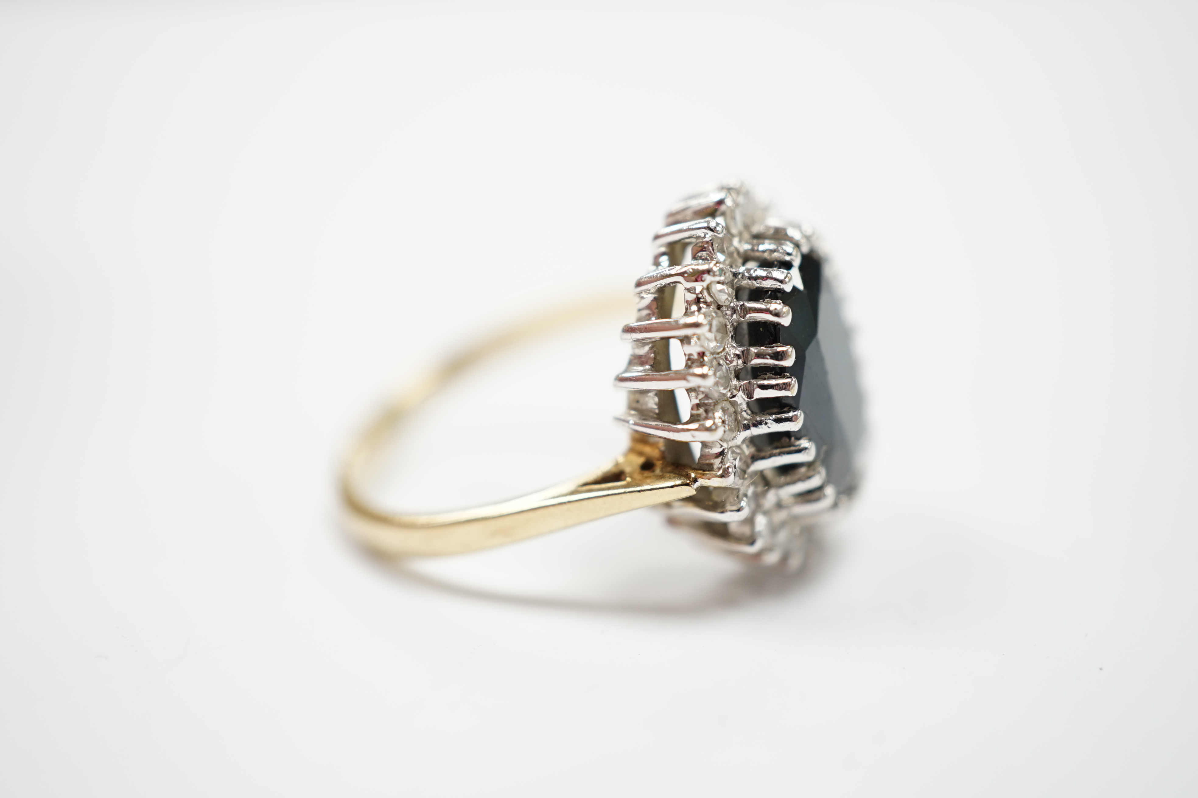A modern 9ct gold, sapphire and diamond set oval cluster ring, size N/O, gross weight 4.8 grams.